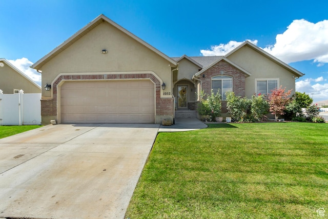 1052 S 350 E, Payson, UT 84651 - view of front of property featuring a garage, stucco siding, concrete driveway, and brick siding