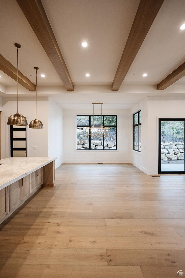 672 Skyview Cir N, Salt Lake, UT 84054 - interior space featuring light wood-type flooring, beam ceiling, and plenty of natural light