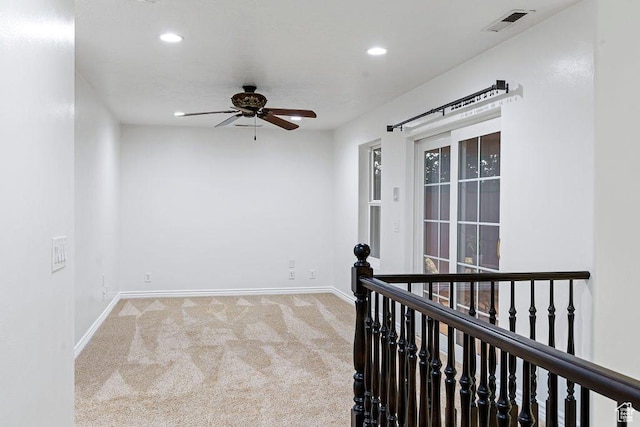 spare room with visible vents, carpet, baseboards, recessed lighting, and a ceiling fan