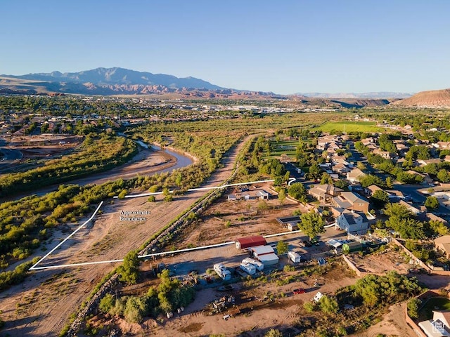 birds eye view of property with a mountain view