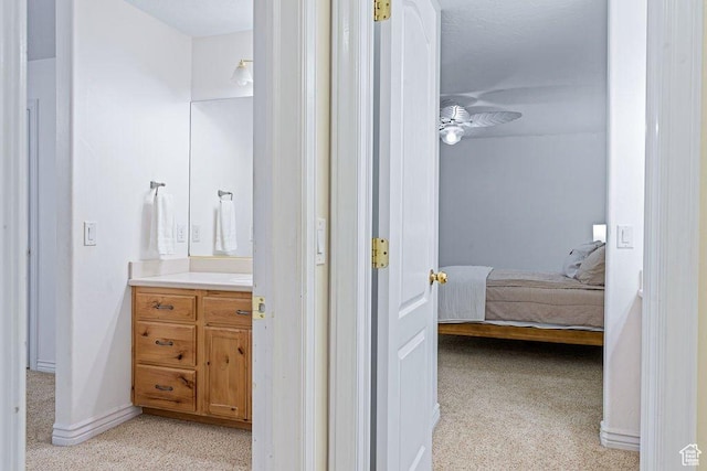 bathroom featuring carpet flooring, vanity, ensuite bathroom, and ceiling fan