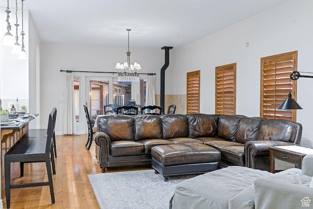 living area featuring a chandelier and light wood-type flooring