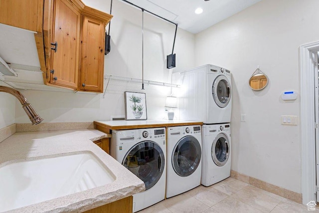 washroom with stacked washer / drying machine, a sink, washer and dryer, cabinet space, and light tile patterned floors