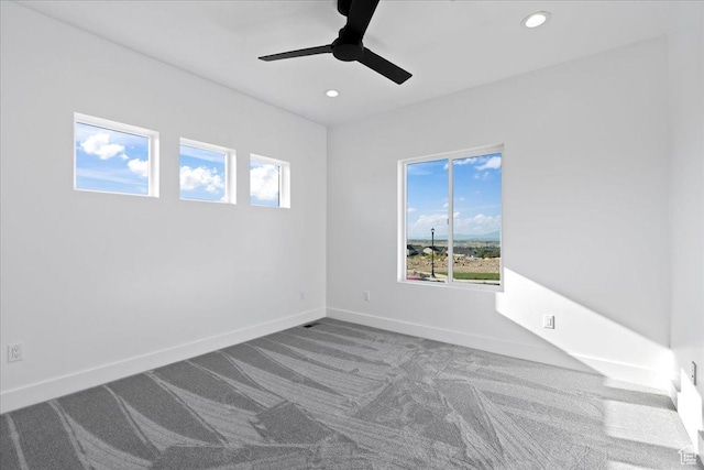 unfurnished room with baseboards, a ceiling fan, recessed lighting, and carpet