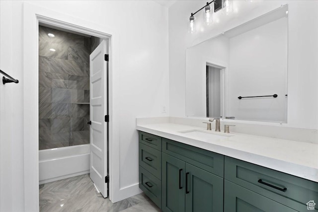 bathroom with marble finish floor, shower / bathing tub combination, and vanity