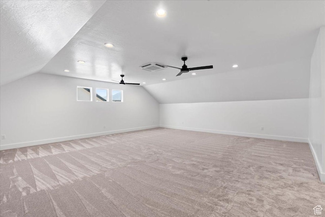additional living space with baseboards, carpet floors, ceiling fan, and lofted ceiling