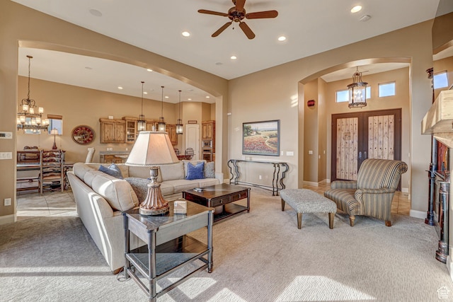 4985 W Boulder Vw, Hurricane, UT 84737 - living room featuring arched walkways, ceiling fan with notable chandelier, and light carpet