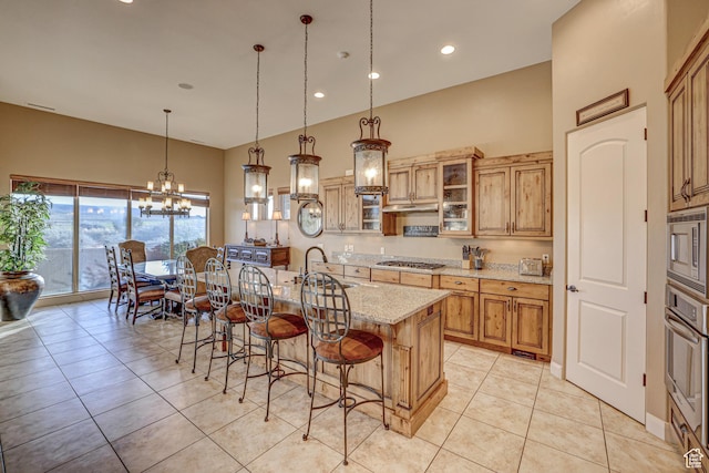 4985 W Boulder Vw, Hurricane, UT 84737 - kitchen featuring stainless steel appliances, a sink, light stone counters, a breakfast bar area, and a notable chandelier