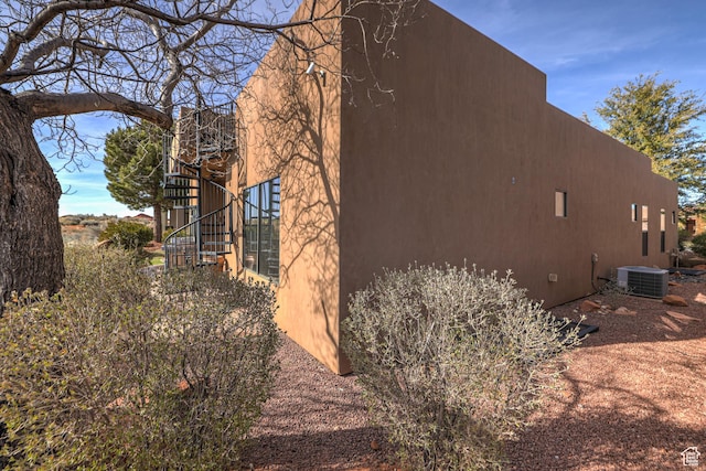 4985 W Boulder Vw, Hurricane, UT 84737 - view of side of home with central air condition unit, stairs, and stucco siding