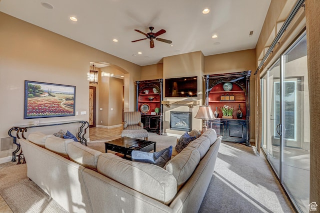 4985 W Boulder Vw, Hurricane, UT 84737 - living room featuring recessed lighting, carpet, arched walkways, ceiling fan, and a glass covered fireplace
