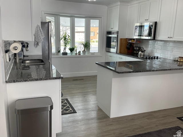 466 W 200 N, Logan, UT 84321 - kitchen with tasteful backsplash, dark stone countertops, stainless steel appliances, and a sink