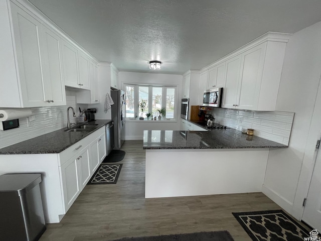 466 W 200 N, Logan, UT 84321 - kitchen featuring a sink, appliances with stainless steel finishes, dark wood-style floors, and white cabinets
