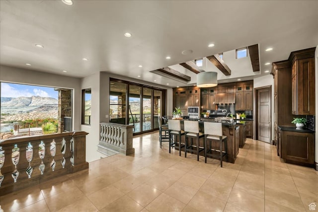 2196 W Long Sky Dr, St George, UT 84770 - kitchen featuring a large island with sink, glass insert cabinets, a kitchen breakfast bar, recessed lighting, and light tile patterned flooring