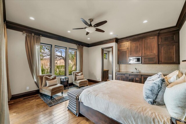 2196 W Long Sky Dr, St George, UT 84770 - bedroom featuring baseboards, light wood-style floors, a sink, and ornamental molding