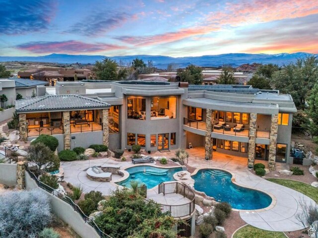 2196 W Long Sky Dr, St George, UT 84770 - rear view of house with a mountain view, a fenced backyard, a patio, and a balcony