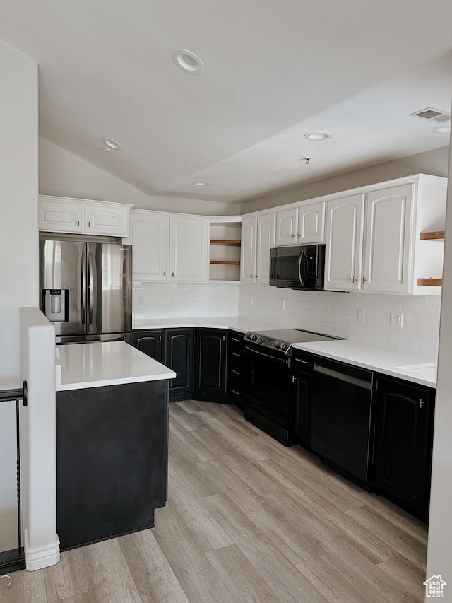 kitchen with open shelves, dark cabinetry, light wood-style floors, white cabinets, and black appliances