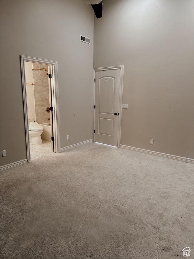 interior space featuring baseboards, visible vents, and carpet flooring