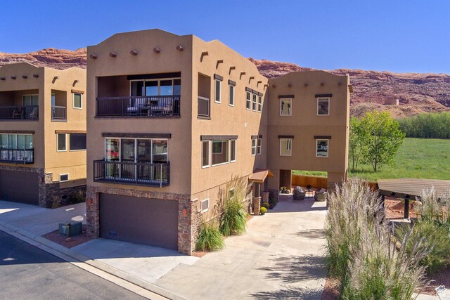 1261 N Main Rubicon Trl Unit M-14, Moab, UT 84532 - view of property with concrete driveway, a mountain view, and a garage