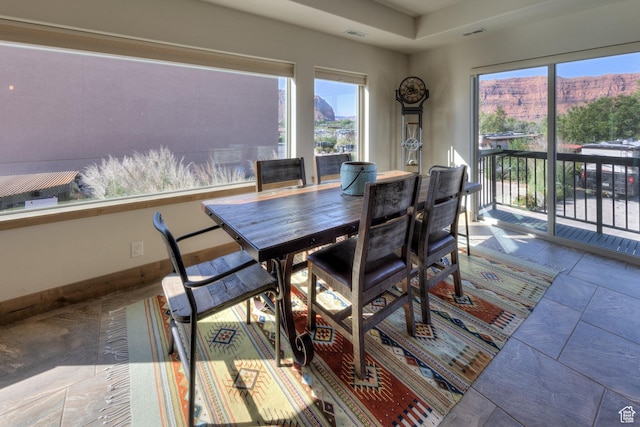 1261 N Main Rubicon Trl Unit M-14, Moab, UT 84532 - dining space with plenty of natural light, a mountain view, visible vents, and stone tile floors