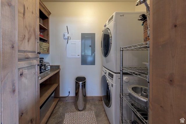 1261 N Main Rubicon Trl Unit M-14, Moab, UT 84532 - clothes washing area with baseboards, stacked washer and clothes dryer, laundry area, and electric panel