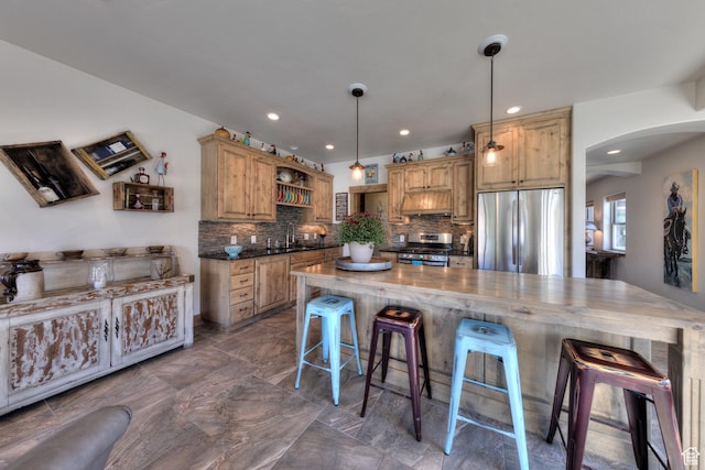 1261 N Main Rubicon Trl Unit M-14, Moab, UT 84532 - kitchen with a kitchen bar, arched walkways, tasteful backsplash, open shelves, and stainless steel appliances
