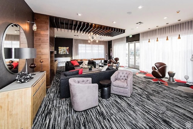 875 S Depot St Unit C212, Clearfield, UT 84015 - interior space featuring wood walls, dark colored carpet, and a notable chandelier