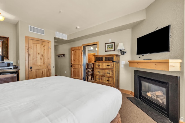 2669 Canyons Resort Dr Unit 206Abc, Park City, UT 84098 - bedroom featuring baseboards, visible vents, carpet floors, and a glass covered fireplace