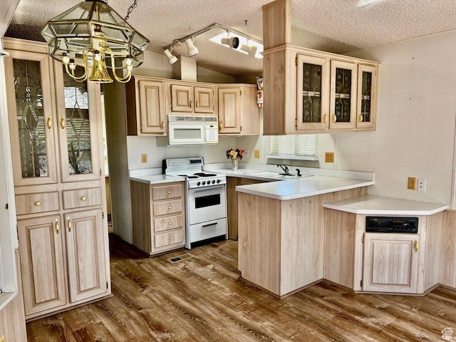 448 E Telegraph # 26, Washington, UT 84780 - kitchen featuring lofted ceiling, white appliances, light brown cabinetry, dark wood-type flooring, and a chandelier