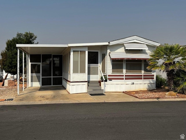 manufactured / mobile home with an attached carport and a sunroom