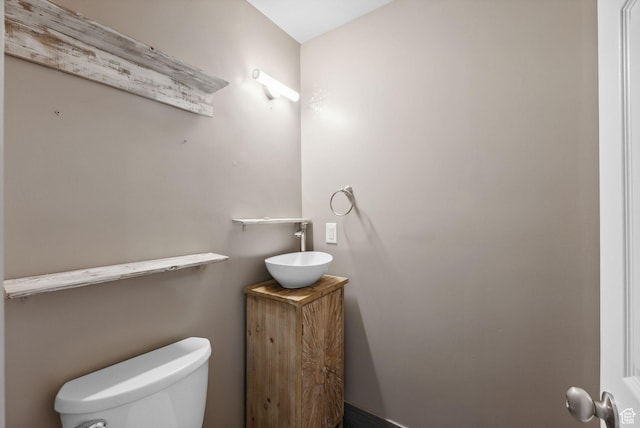 half bath featuring toilet and a sink