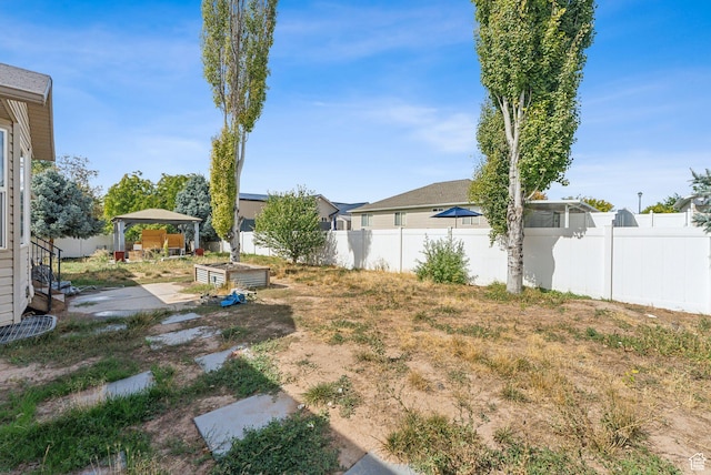 view of yard with a gazebo, a patio, and fence