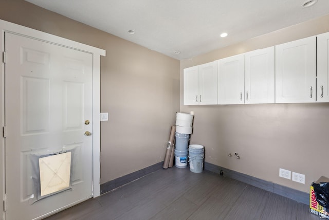 washroom featuring baseboards, dark wood-style flooring, recessed lighting, and cabinet space