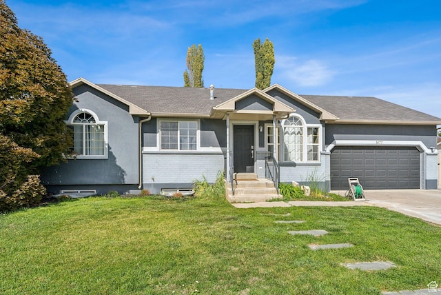 view of front of home with concrete driveway, a front yard, stucco siding, and a garage