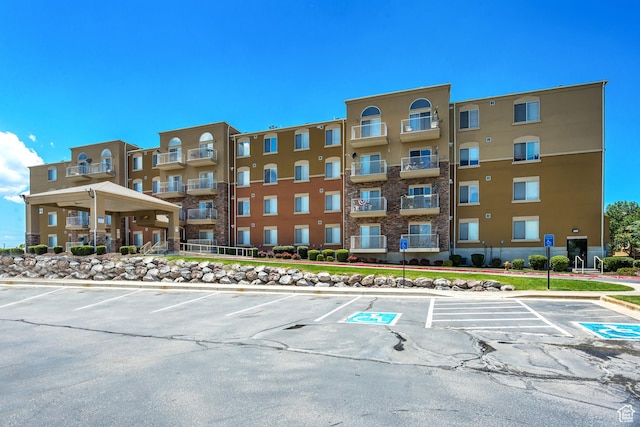 view of property featuring uncovered parking