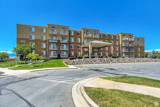 3478 S Cozy River Pl Unit 402, West Valley City, UT 84119 - view of building exterior with uncovered parking