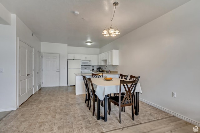 3478 S Cozy River Pl Unit 402, West Valley City, UT 84119 - dining room with baseboards and an inviting chandelier