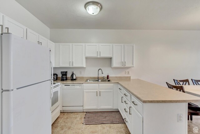 3478 S Cozy River Pl Unit 402, West Valley City, UT 84119 - kitchen with white cabinetry, light countertops, white appliances, a sink, and a peninsula