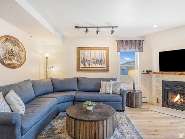 424 Park Ave Unit D, Park City, UT 84060 - living room featuring rail lighting, light wood-style flooring, a baseboard heating unit, a tiled fireplace, and recessed lighting