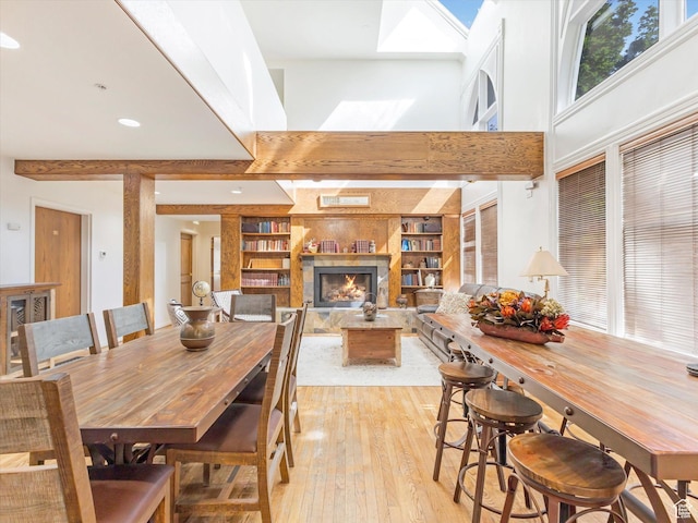 424 Park Ave Unit D, Park City, UT 84060 - dining room featuring light wood-type flooring, a high ceiling, a lit fireplace, and built in features
