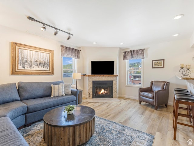 424 Park Ave Unit D, Park City, UT 84060 - living room featuring plenty of natural light, light wood-style flooring, a tiled fireplace, track lighting, and recessed lighting