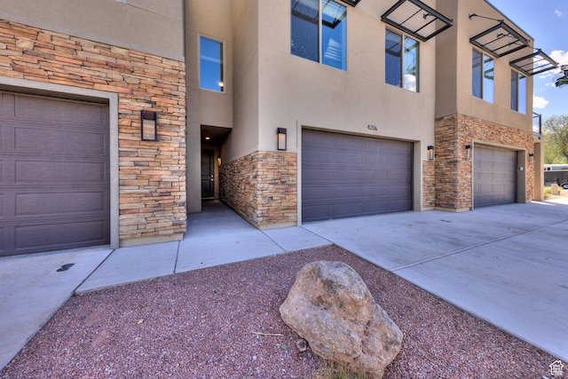 420 N 600 W, Moab, UT 84532 - view of front of home featuring stone siding, stucco siding, an attached garage, and driveway