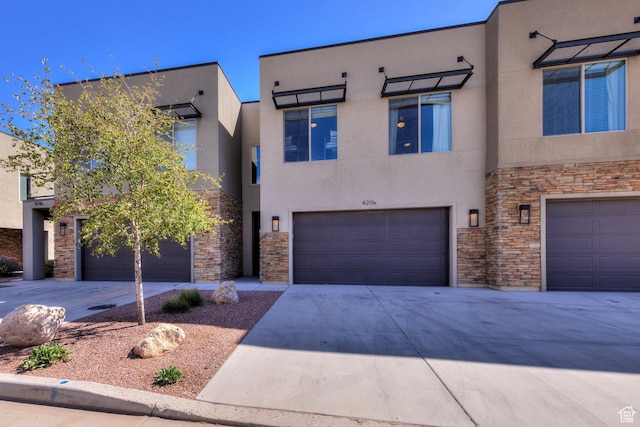 420 N 600 W, Moab, UT 84532 - view of front of property with stone siding, stucco siding, a garage, and concrete driveway