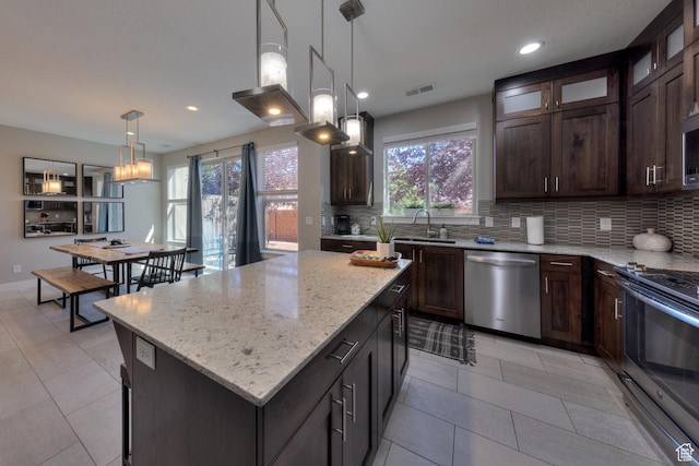 420 N 600 W, Moab, UT 84532 - kitchen featuring appliances with stainless steel finishes, decorative backsplash, a sink, dark brown cabinets, and recessed lighting
