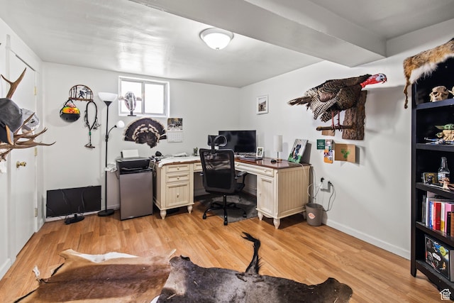 office area with light wood finished floors and baseboards