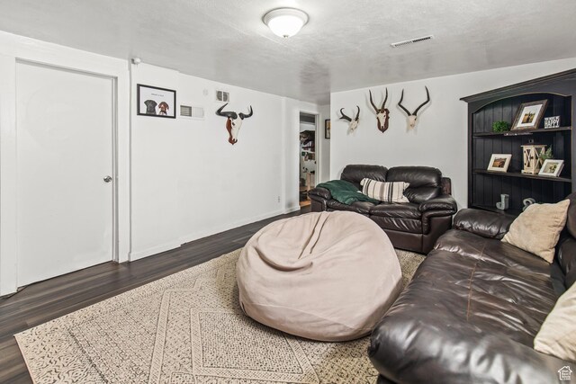 living room with visible vents and wood finished floors