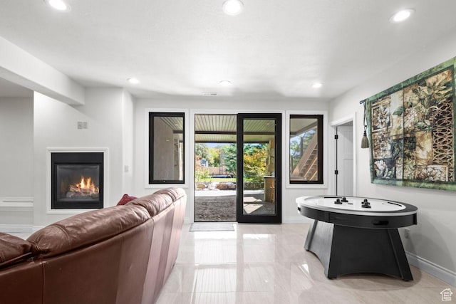 10575 S Alexander Park Ln, South Jordan, UT 84095 - living room with a glass covered fireplace, recessed lighting, marble finish floor, and baseboards