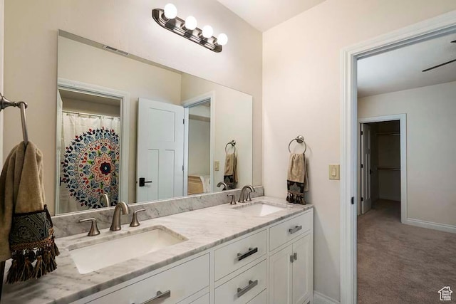 10575 S Alexander Park Ln, South Jordan, UT 84095 - bathroom with visible vents, double vanity, a sink, and baseboards