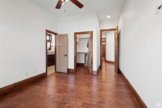10575 S Alexander Park Ln, South Jordan, UT 84095 - unfurnished bedroom with baseboards, a walk in closet, connected bathroom, and dark wood-style floors