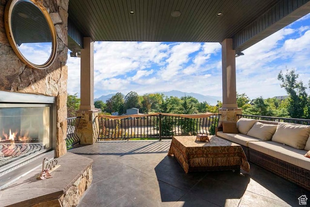 10575 S Alexander Park Ln, South Jordan, UT 84095 - view of patio / terrace featuring a mountain view and an outdoor living space with a fireplace