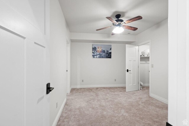 10575 S Alexander Park Ln, South Jordan, UT 84095 - unfurnished bedroom with a closet, a ceiling fan, light carpet, a walk in closet, and baseboards
